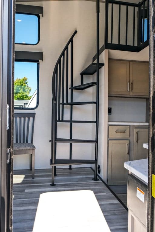 Facing spiral stairs toward main loft from entry