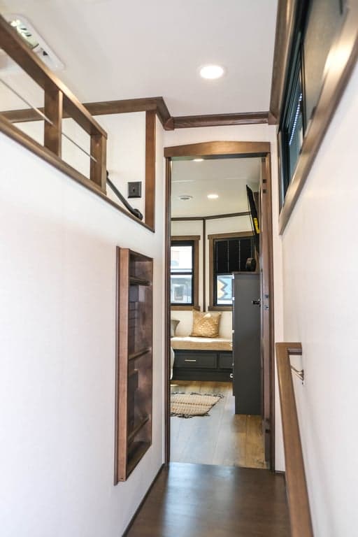 Hallway to front bedroom with loft on left