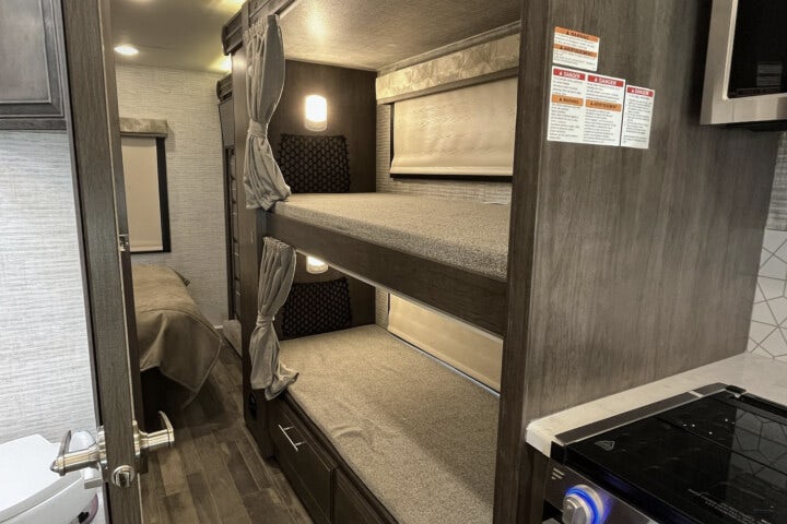 Bunk beds with personal TVs in the Entegra Esteem 31F